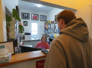 customer at reception Redwood Physio 